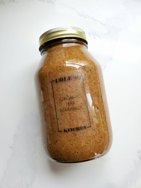 Large 32 oz (1 L) glass mason jar of Cole's Kitchen Organic Jerk Marinade with a gold lid, showcasing the thick, authentic spice blend.